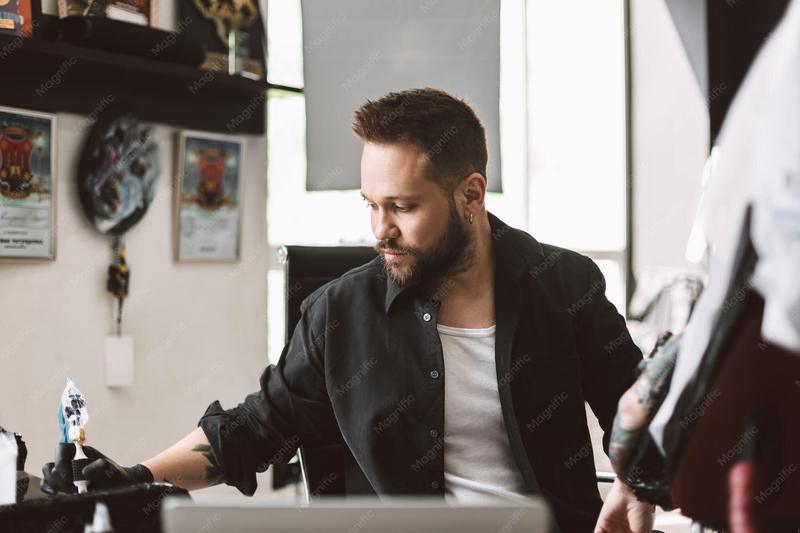 A tattoo artist setting up in a studio