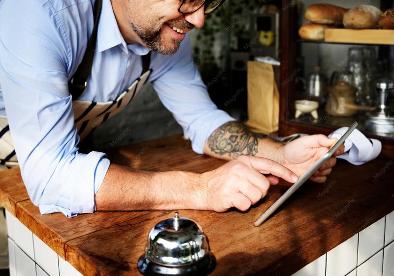 A baker checking a tablet in the shop