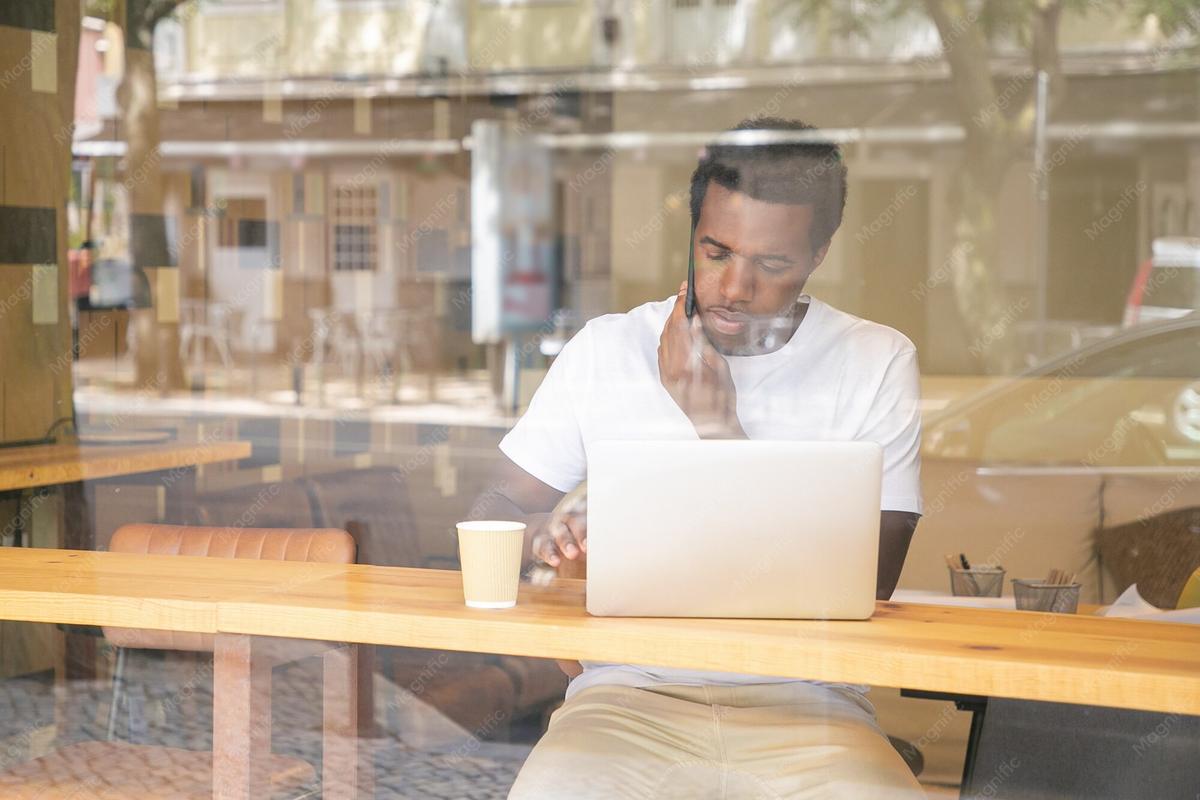 A business owner on the phone with a laptop open